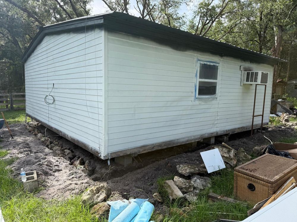Building before work, old siding on block piers