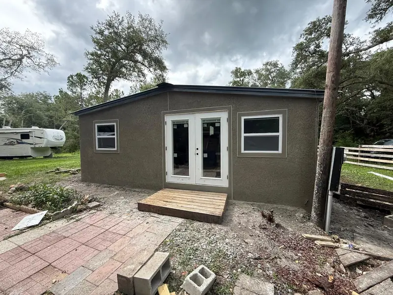 Finished stucco exterior with crisp white doors and trim