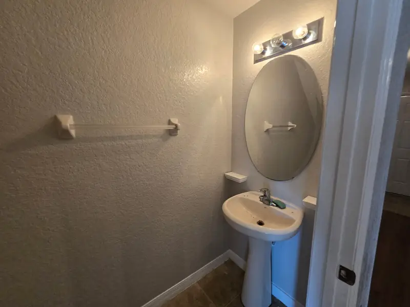 Half bath refreshed with clean, crisp walls